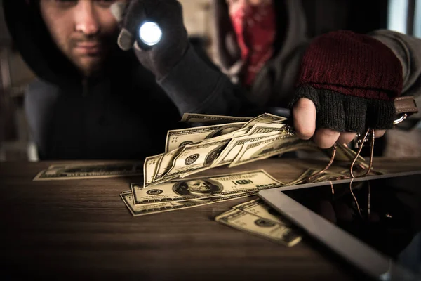 depositphotos_150247624-stock-photo-robbers-stealing-money