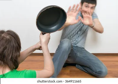 wife-attacking-her-husband-frying-260nw-364911665