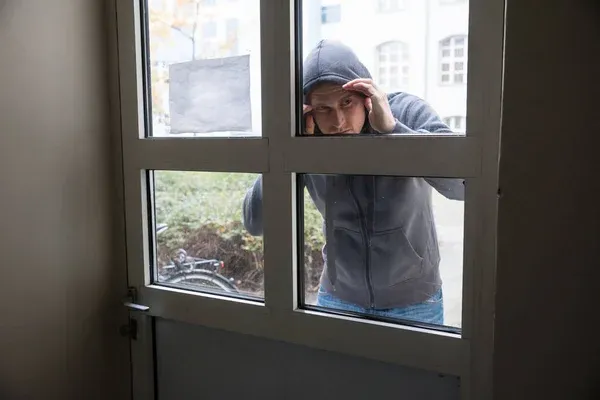 depositphotos_139880880-stock-photo-thief-looking-through-door