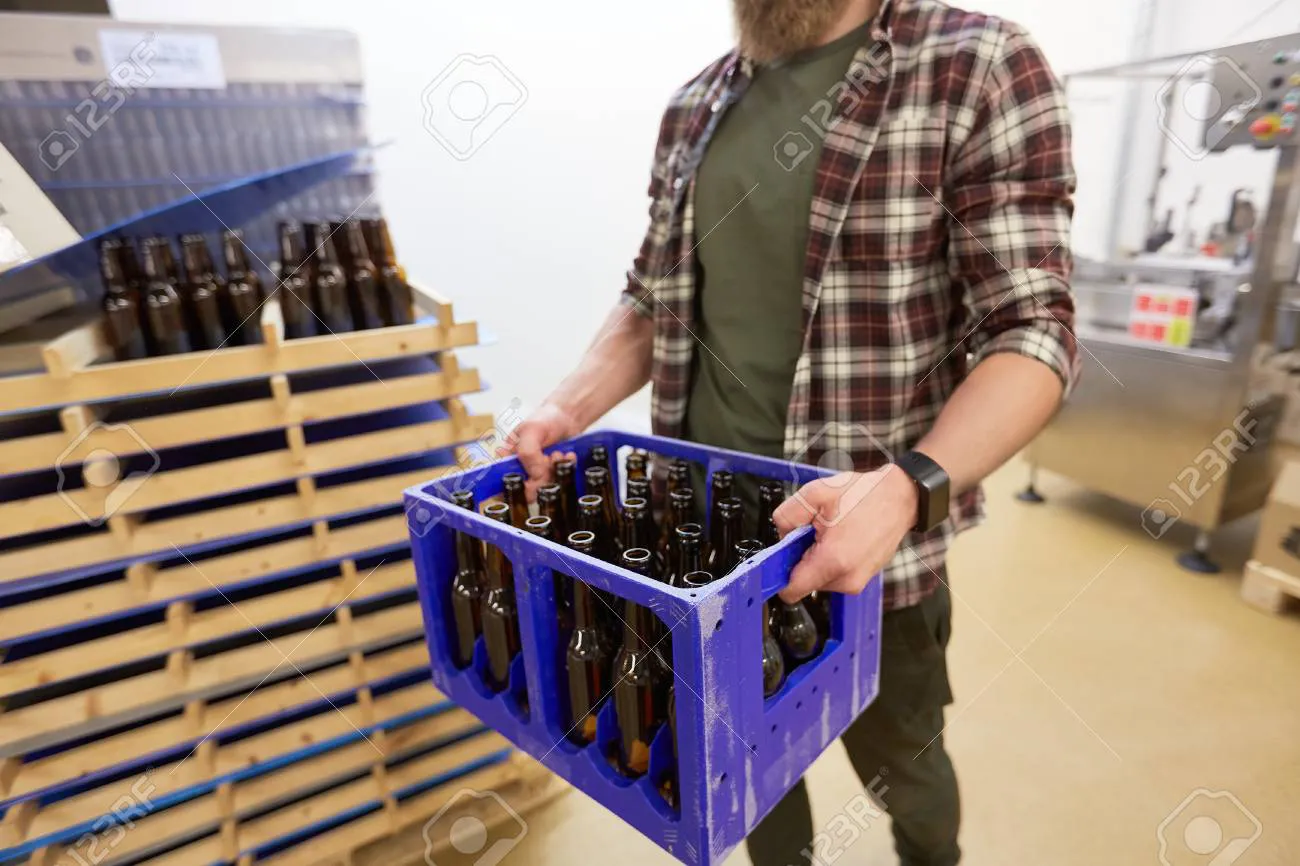 84628039-man-with-bottles-in-box-at-craft-beer-brewery
